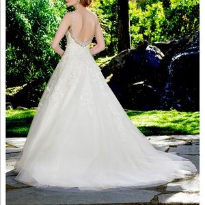 Backless, jewel and lace detailed wedding dress.